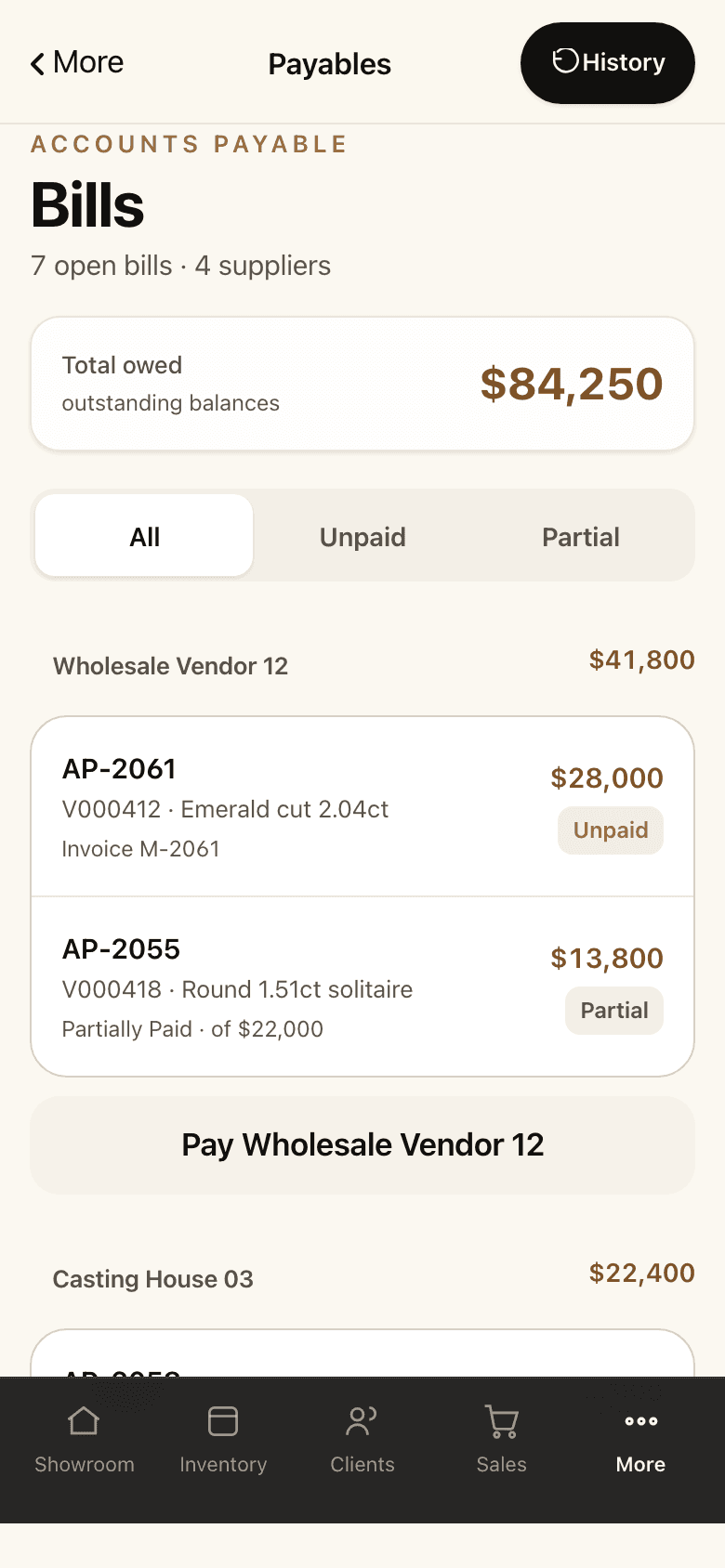 The payables screen on a phone: the total owed, open bills grouped by supplier, and a pay button for each.